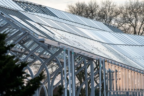 the side of a conservatory showcasing steel beams and glass